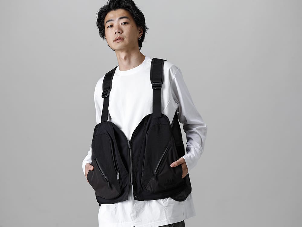 White Mountaineering - ホワイトマウンテニアリング 2022-23AW ミリタリーのベストのフォルムやディテールを参考に、アウトドアとタウンユースを横断できるアイテムへと解釈しました。 コントラストを効かしたホワイトマウンテニアリングとリップヴァンウィンクルのミックススタイル -  BK2273204 BLK キャンピング ベスト - RB-402-White クロスジャージー L/S ホワイト